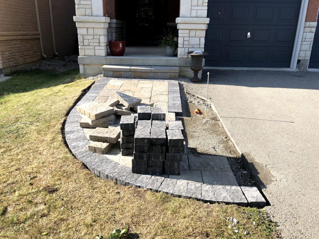 front yard sodding and interlocking in progress of stone layout- best lawn care toronto